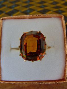 Wow! What a exquisite 10KtYg Lab Created Orange Sapphire.  Size 8 3/4 with the Solitaire stone at approximately 12 Carats. 7.5 g.  Stamped 10KtYg inside.  The fire in this stone is beyond eye catching.  Can be resized or a ring guard added.  Stone is prong set.  I have my jeweler and his gemologist wife look at each estate jewelry that I have.  This preloved ring is coming from a clean nonsmoking home. Luxury Amber Topaz Wedding Ring, Classic Luxury Orange Topaz Ring, Luxury Amber Engagement Ring, Luxury Orange Topaz Wedding Ring, Luxury Classic Orange Topaz Ring, Luxury Amber Topaz Ring In Classic Style, Luxury Amber Topaz Ring Elegant Style, Engagement Rings Amber Stone, Luxury Classic Amber Topaz Ring