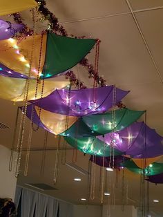 many colorful umbrellas hanging from the ceiling