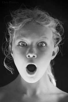 a woman making a surprised face with her mouth open