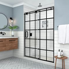 a bathroom with a shower, sink and mirror