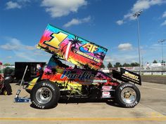 a modified race car is parked in a parking lot