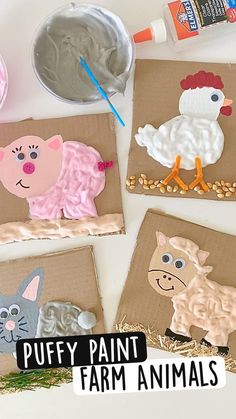 four farm animals made out of cardboard on a table with paint and glue next to them