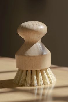 a wooden brush sitting on top of a table