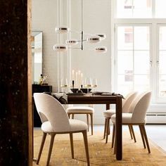 a dining room table with chairs and a chandelier