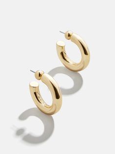 The perfect lightweight chunky gold hoops are just a click away. Our Dalilah Earrings are a must-have jewelry essential for your arsenal. Thick tubes of metal are crafted in a timeless hoop shape and topped off with a comfortable post-back closure. Lightweight and easy to layer (if you so choose), you're bound to reach for these staples again and again. Thick Gold Hoop Earrings, Thick Gold Hoops, Bridal Earrings Studs, Bauble Bar, Ups Shipping, Safety Pin Earrings, 18k Gold Earrings, Dope Jewelry, Jewelry Essentials