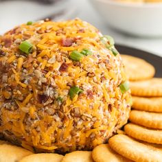 a cheese ball is sitting on top of crackers