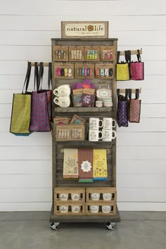 a display case with coffee cups, mugs and other items on top of it