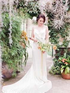 a woman in a white dress holding flowers