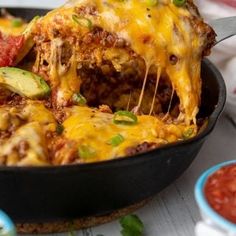 a close up of a casserole in a pan with cheese and vegetables on top