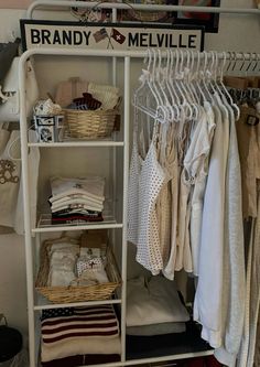 an organized closet with clothes and baskets