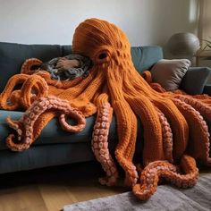 an octopus blanket is laying on a couch