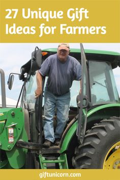 a man standing on the back of a green tractor