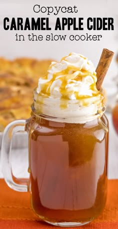 caramel apple cider in a glass mug with whipped cream and cinnamon on top