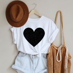 "Womens Heart Shirt, Black Glitter Heart Tshirt, Festival Rave Clothes Women, Heart Tee Shirt, Gifts for Women, Casual Clothes, Friends Gift HOW TO ORDER 1. Select the size and color of the shirt you would like to order. 2. Add the quantity of shirt(s) you would like and then click \"Add to Cart\" 3. Submit Order 4. During checkout please provide any additional information in the \"Note to Seller\" section. If you forget, just send me a message on Etsy after your order is completed. BLACK HEART Heart Tee Shirt, Festival Clothes, Heart Tshirt, Festival Outfits Women, Texas Shirts, Heart Tee, Bella Canvas Tees, Glitter Hearts, Clothes Women