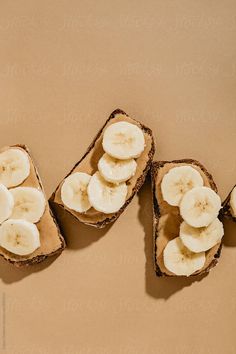 sliced bananas and peanut butter on toasted bread by jordil for stockstuffs