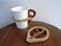 a cup and spoon on a wooden table