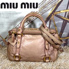 Authentic Vitello Lux Mini Bow Bag By Miu Miu Is Edge Daytime To Nighttime Bag With Feminine Finish. This Bag Is Made From Smooth Versatile Light Pink Leather With Luxe Miu Miu Gold-Tone Hardware. It Is Accented With A Front Miu Miu Label, Lovely Side Bows, Double Flat Handles, Removable Crossbody Strap (Hardware Has Been Repaired) The Interior Is Purple Satin In Used Condition Might Have Odor, Paint, Stained Please Review All Pictures And Feel Free To Ask Questions To Avoid Buyer’s Remorse @Jayr007 Miu Miu Bag With Adjustable Strap For Everyday Use, Miu Miu Bags With Adjustable Strap For Everyday Use, Miu Miu Satchel With Adjustable Strap, Miu Miu Shoulder Bag With Adjustable Strap, Chic Miu Miu Bag With Adjustable Strap, Miu Miu Evening Bags With Top Carry Handle, Miu Miu Evening Shoulder Bag With Top Carry Handle, Miu Miu Beige Shoulder Bag For Everyday, Beige Miu Miu Shoulder Bag For Everyday Use