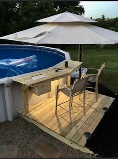 an above ground swimming pool with table and chairs