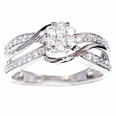 a white gold ring with diamonds on the band and an oval shaped diamond in the center