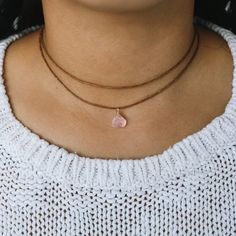 Rose quartz is the stone of unconditional love. It opens up the heart, increasing self-love, friendship, healing, and inner peace--establishing greater compassion, trust, and harmony in oneself and relationships. This is a raw Rose quartz choker which is wrapped with our high quality wire. Fully adjustable with a sliding pearl on our premium cotton cord.  ✺ COLOR ✺  Three different colors are available for waxed cotton cord: -Beige (natural color) -Brown -Black and two colors for wire:  -Gold (g Raw Rose Quartz Necklace, Quartz Choker, Layered Choker Necklace, Raw Rose Quartz, Necklace Layered, Gold G, Layered Chokers, Rose Quartz Necklace, Rose Quartz Stone