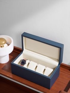 Meticulous about craftsmanship, Pinel et Pinel handmakes everything at its dedicated workshops in Paris. This 'Tarmac' watch box is made from full-grain leather with four sections to keep your timepieces secure. Elegant Blue Rectangular Watch Accessories, Blue Leather Strap Watch Accessories Gift, Rectangular Blue Watch Accessories For Gift, Designer Blue Watch For Gift, Designer Blue Watch As Gift, Designer Blue Watches As Gift, Designer Blue Watches Gift, Elegant Blue Watch Accessories For Gift, Elegant Blue Watch Accessories As Gift