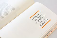 an open book with some writing on the page and orange lines in it's center