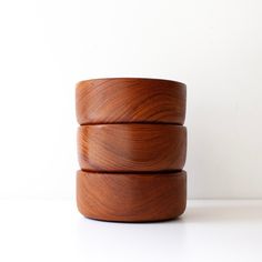 three wooden bowls stacked on top of each other