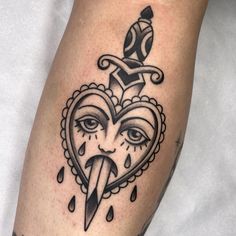 a black and white tattoo on the leg of a person with a knife sticking out of it