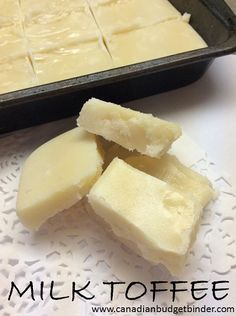 sliced pieces of cheese sitting on top of a white doily next to a pan