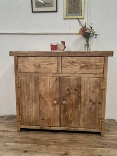 a wooden cabinet with two doors and drawers