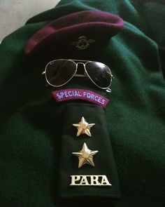 a green uniform with gold stars and sunglasses on the lapel that says special forces