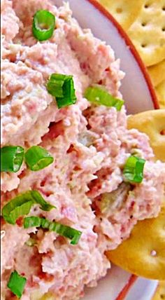 a white plate topped with crackers and tuna salad