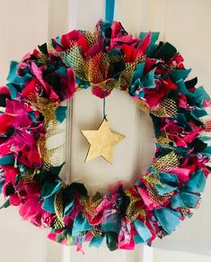 a colorful wreath with a star hanging from it