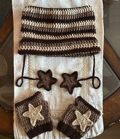 a crocheted hat, mitts and scarf on a table