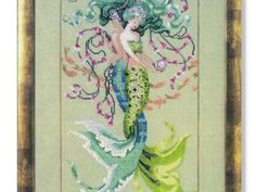 a cross stitch pattern with a mermaid holding a flower in it's hand and an ornate frame