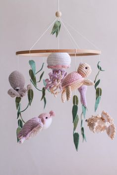 a crocheted mobile with sea animals hanging from it's sides and leaves