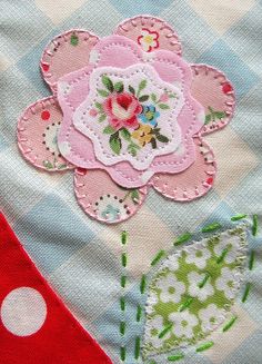 a patchwork piece with flowers and polka dots on it