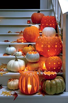 pumpkins and candles are sitting on the steps