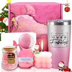 a pink christmas gift box with candles, soap and other items