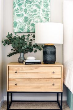 an image of a bedroom with plants on the nightstand and bed in the background, which is instagram