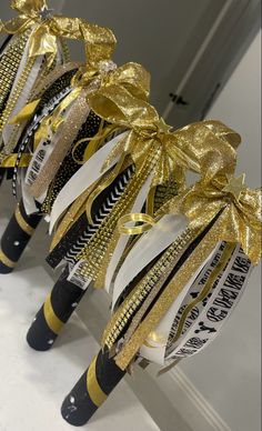 Black and gold cheer spirit sticks Cheerleader Spirit Sticks, Diy Cheer Spirit Sticks, School Spirit Stick, Spirt Stick Ideas, Spirit Stick Ideas Diy Cheer, Cheer Sticks Spirit Diy, How To Make A Spirit Stick Cheer, Spirit Stick Decorating Ideas