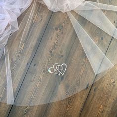 wedding veil and sticker on wooden floor with white tulle overlaying it