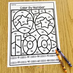 a color by number worksheet with crayons and markers on a table