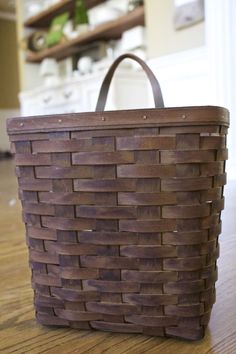 a brown basket sitting on top of a wooden table