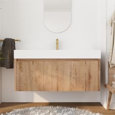 a bathroom with a sink, mirror and rug