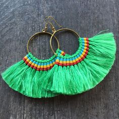 Long fun big green tassel earrings. Made with a brass hoop, green string and wax cord.All put together creating this unique pair. They are super light what makes them easy and fun to wear. The earrings are 7cm- 2.75 inch long 10cm-4 inch wide more or less. This are the perfect addition to your earring collection. To see more unique tassel colorful earrings, click the link below https://www.etsy.com/shop/AkashiJewelry?ref=seller-platform-mcnav&section_id=27118797 ⚡️Join Akashi's VIP list for Green Tassel Beach Earrings, Beach Green Tassel Earrings, Bohemian Green Tassel Earrings For Beach, Green Tassel Earrings With Fringe For Festivals, Bohemian Rainbow Tassel Earrings, Green Bohemian Tassel Earrings With Fringe, Bohemian Green Tassel Earrings With Fringe, Bohemian Green Tassel Fringe Earrings, Green Fringed Beach Jewelry