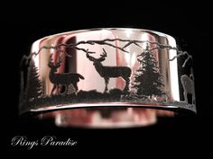 a ring with deer and trees on it