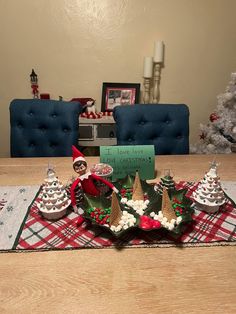 a table topped with cakes and elf hats