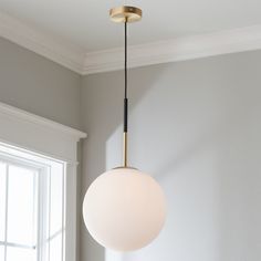 a white light hanging from a ceiling in a room