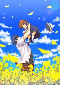 a man holding a child in his arms while flying through the air over yellow flowers